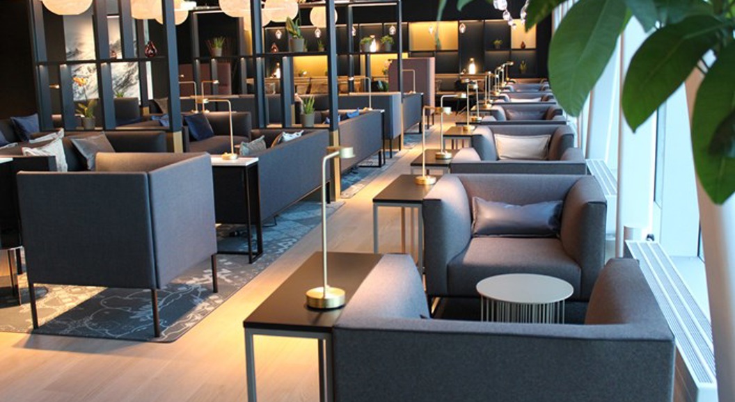 Moderne flyplasslounge med elegante sitteplasser, stemningsfull belysning og moderne dekor, som skaper et komfortabelt og stilfullt miljø for reisende