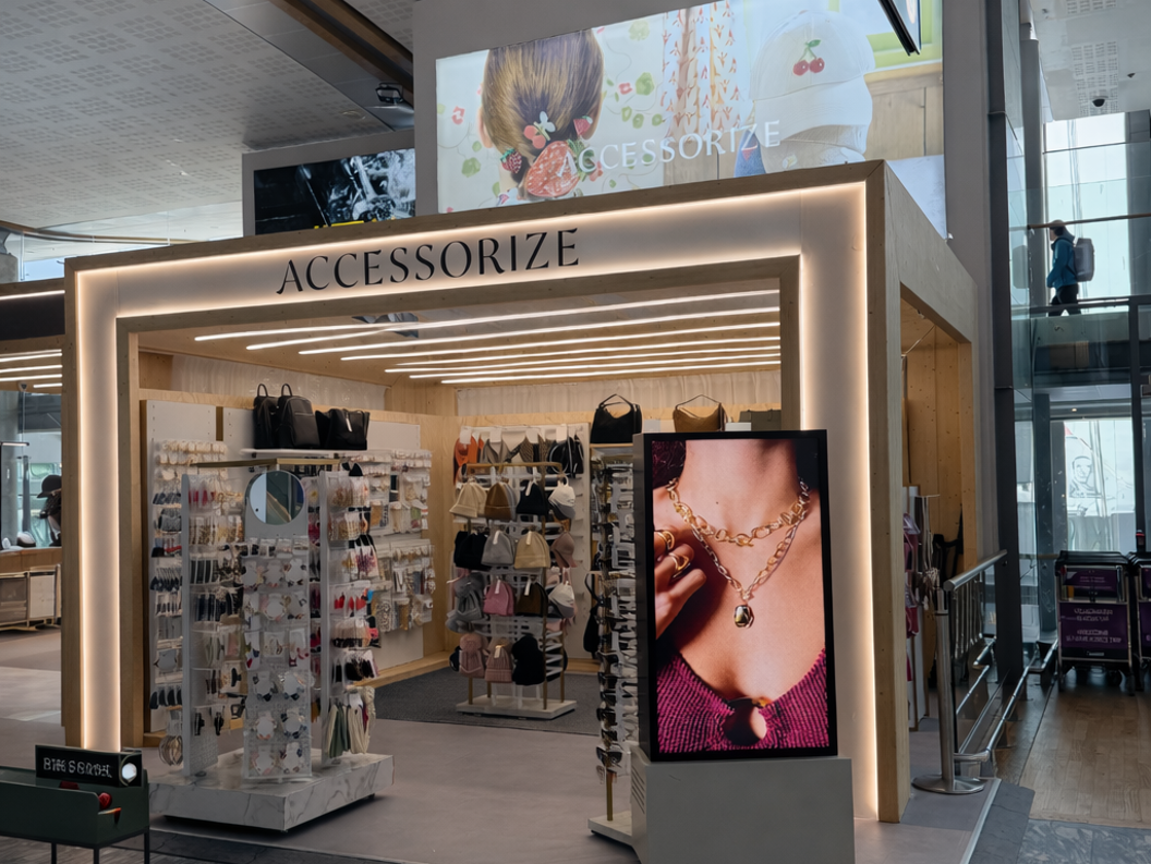 Facade image of Accessorize featuring products and a large commercial screen at the front.