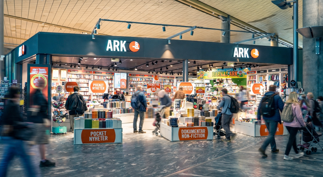Woman browsing colorful children's books on a bookstore shelf