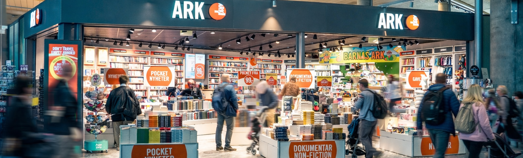 Woman browsing colorful children's books on a bookstore shelf