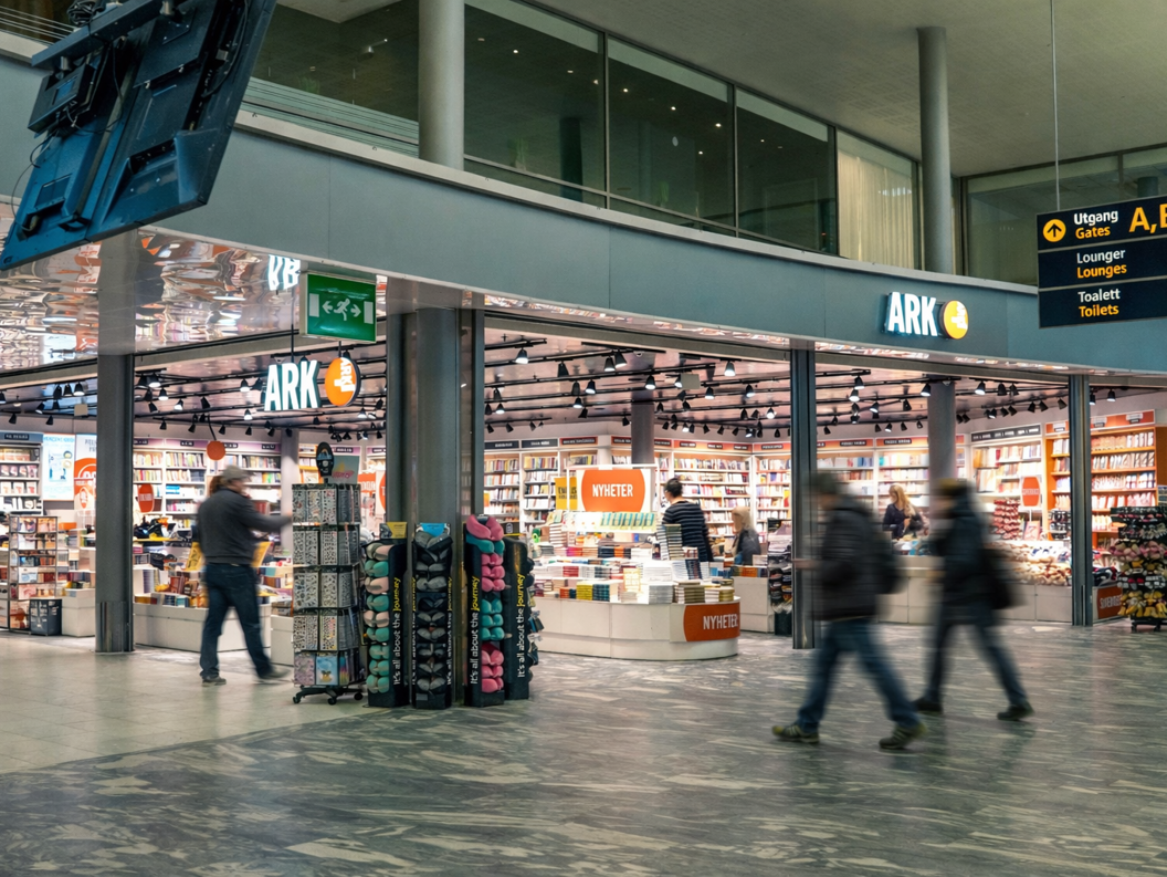 Woman looking at children's books in a bookstore. Handpicking a book from the shelf in the 9-12 age group section.