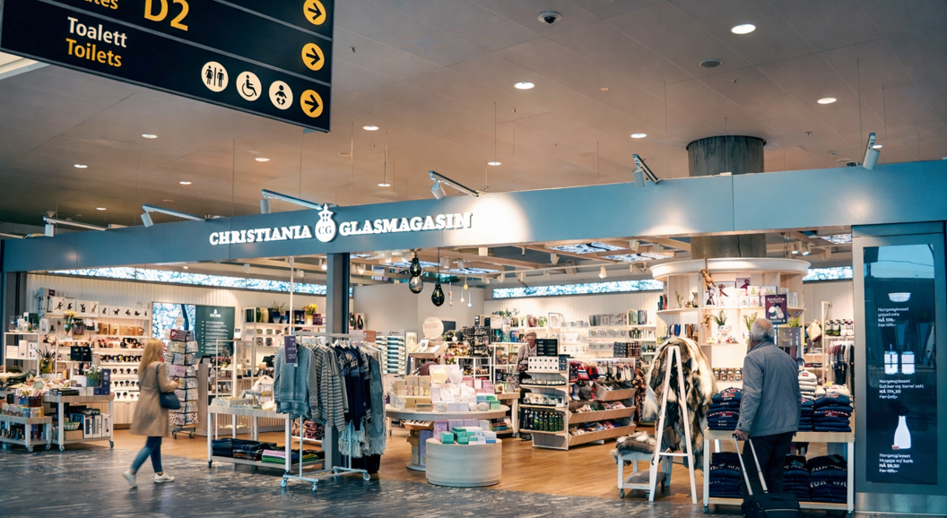 Storefront of Christiania Glasmagasin featuring a well-lit display of jewelry, clothing, and home decor items in a modern shopping mall setting