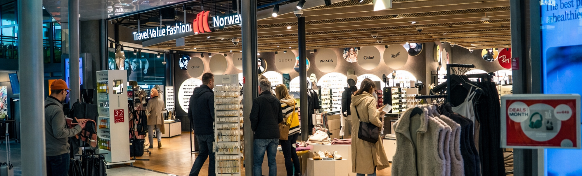 Person shopping for Persol sunglasses at an eyewear store display