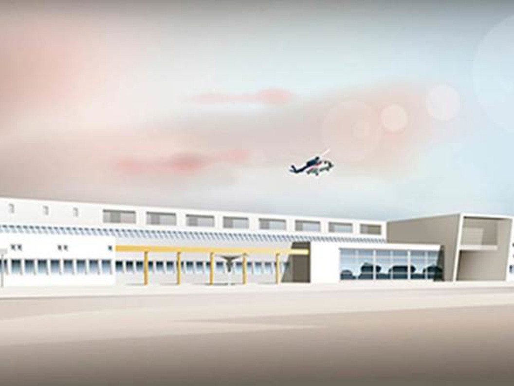 Flyplassbygning med moderne design, sett i dagslys med helikopter som svever i bakgrunnen.